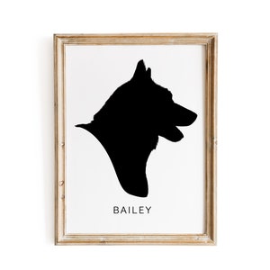 May include: A framed black and white silhouette of a dog's head, with the name "BAILEY" printed below the image.