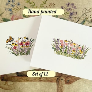 May include: Set of 12 hand-painted note cards featuring a floral design with bees and a butterfly. The cards are blank inside and perfect for sending a handwritten note.
