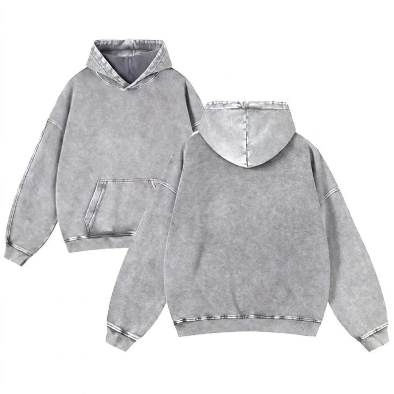 May include: Two grey hoodies with a washed-out effect are shown. The hoodies have a front pocket and a hood. The fabric has a textured appearance. The hoodies are casual wear.