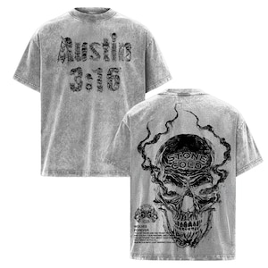 May include: Grey acid wash t-shirt with black graphic text and skull design. The front of the shirt features the text "Austin 3:16". The back of the shirt has a skull with the words "Stone Cold" and additional text.