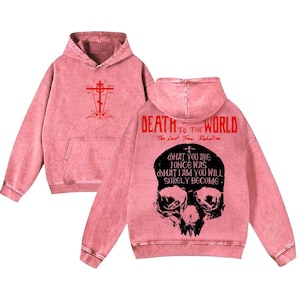 May include: Pink hoodie with a front graphic of a cross and a back graphic featuring a skull and the text "DEATH TO THE WORLD". The hoodie also has the text "The Last True Rebellion" and a quote.