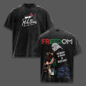 May include: Dark gray t-shirt with a distressed look. The front features the word "Palestine" in white script, a flag graphic, and the text "WILL BE FREE!". The back displays the word "FREEDOM" and a person holding a flag.