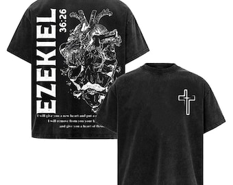 May include: Two black t-shirts with a faded appearance. One has a white cross on the front. The other displays the word "EZEKIEL", the number "36:26", a heart graphic, and text from a Bible verse in white.