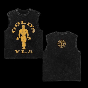 May include: Black sleeveless shirt with a distressed look. The front features the text "GOLD'S" above a muscular figure holding dumbbells, with "YLA" below. The back displays a circular logo with "GOLD'S GYM".