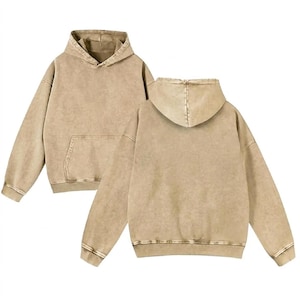 May include: Two views of a tan hoodie with a front pocket and a hood. The hoodie has a faded, vintage appearance. The stitching is visible around the hood and the bottom hem. The hoodie is made of a soft, comfortable material.