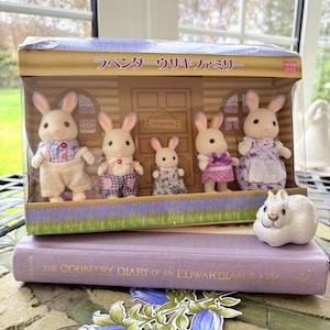 May include: A set of three ceramic mugs with a speckled, matte finish. The mugs are in shades of cream, light gray, and dark gray. Each mug has a simple, minimalist design and a rounded handle.