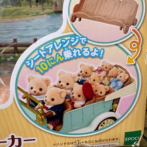 May include: A toy set featuring a light blue vintage car filled with small teddy bear figures. The bears are dressed in various outfits. The packaging includes Japanese text and an illustration of a brown bench with wheels.
