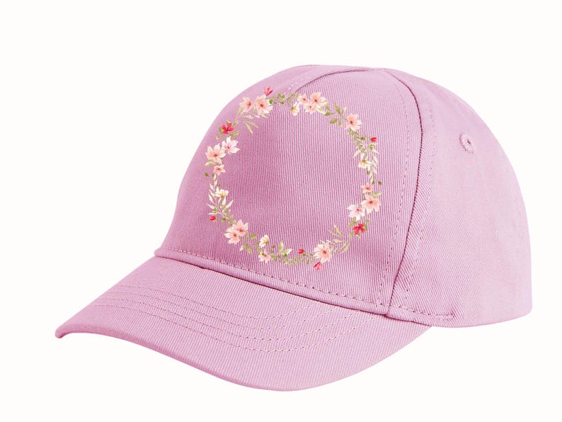 May include: A light purple baseball cap with a floral wreath design. The wreath is composed of small pink and red flowers with green leaves. The cap has a curved brim and a structured crown.