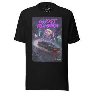 May include: Black t-shirt featuring a graphic of a car racing through a city at night, with the text "GHOST RUNNER" in purple and pink. The image includes the text "REC 03:33 AM".