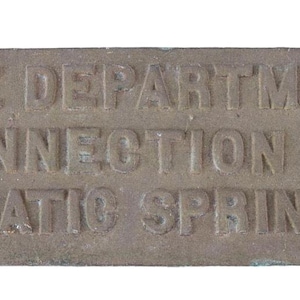 May include: A rectangular metal sign with the text "FIRE DEPARTMENT CONNECTION TO AUTOMATIC SPRINKLERS" embossed in the surface.