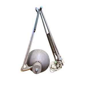 May include: A vintage, articulated desk lamp with a gray, spherical shade and a metallic, adjustable arm. The lamp features a coiled spring and a power cord. The design is industrial and functional, suitable for a workspace or home office.