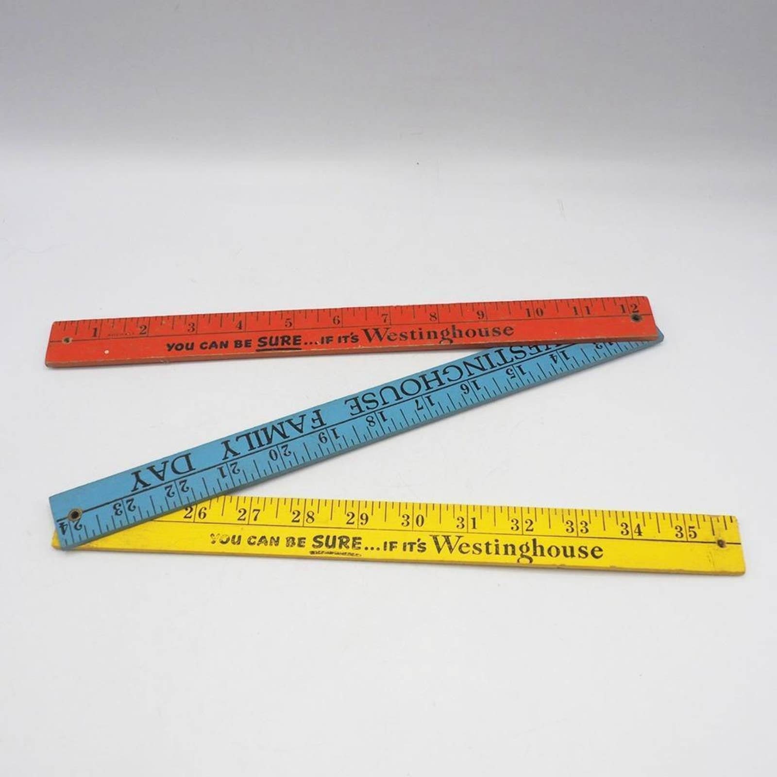 Wooden yardstick with odd number spacing on one side and pointed