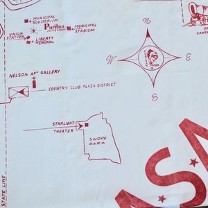 May include: A red and white map of a city with the words "Puritan Maid" and "Origin of Santa Fe Trail".