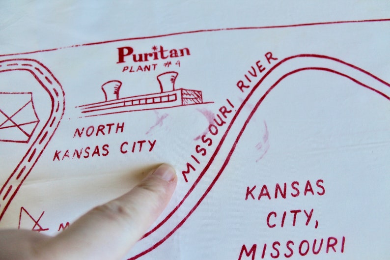 May include: A red and white hand-drawn map of Kansas City, Missouri. The map shows the location of the Puritan Plant #4, the Missouri River, and the text "North Kansas City".