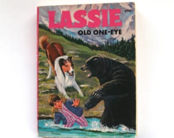 May include: A vintage paperback book cover featuring a collie dog, a bear, and a child in a river. The book title is "Lassie Old One-Eye" with the number 496 printed on the cover.