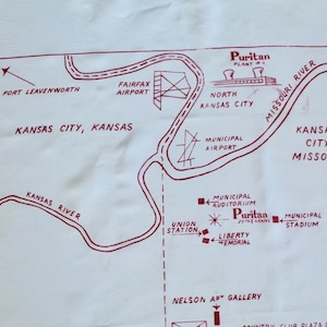 May include: A vintage map of Kansas City, Missouri, with red ink markings showing the location of various landmarks, including the Municipal Airport, Union Station, Liberty Memorial, Municipal Stadium, and the Puritan Plant. The map also shows the Missouri River and the Kansas River.