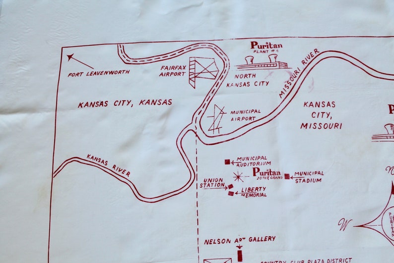 May include: A vintage map of Kansas City, Missouri, with red ink markings showing the location of various landmarks, including the Municipal Airport, Union Station, Liberty Memorial, Municipal Stadium, and the Puritan Plant. The map also shows the Missouri River and the Kansas River.