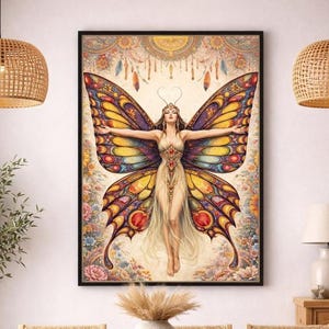 May include: A framed art print featuring a woman with butterfly wings. The artwork showcases a woman with outstretched arms, adorned with a jeweled bodice and flowing gown. The wings are a vibrant mix of yellow, orange, red, and purple. The background is floral with dreamcatcher elements.