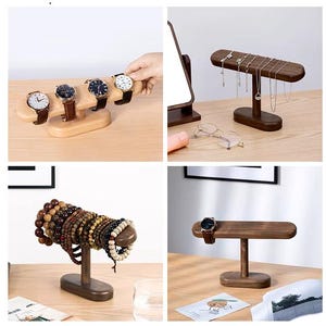 May include: Wooden watch and jewelry display stands. The stands are in various shapes and sizes, showcasing watches, necklaces, and bracelets. The wood has a natural finish, and the stands are arranged on a light-colored surface.