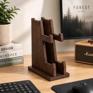 May include: A dark brown wooden stand featuring a vertical back panel and two sets of protruding horizontal supports. The structure is designed with a rectangular base and a tiered configuration, showcasing a natural wood grain finish throughout.