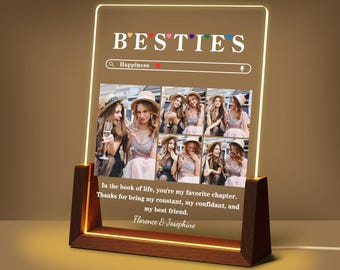 May include: A lighted acrylic sign with the word "BESTIES" above a series of photos. The sign has a wooden base and includes the text "In the book of life, you're my favorite chapter. Thanks for being my constant, my confidant, and my best friend. Florence & Josephine."