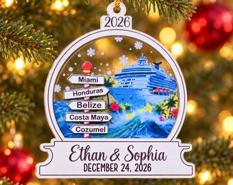 May include: A white, globe-shaped Christmas ornament featuring a cruise ship, tropical foliage, and a signpost with the text Miami, Honduras, Belize, Costa Maya, and Cozumel. The ornament displays the names Ethan & Sophia and December 24, 2026.