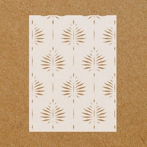 May include: White stencil with a repeating pattern of stylized palm leaves. The stencil is designed for use with paint or other mediums to create a decorative design on walls, furniture, or other surfaces.