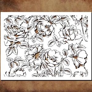 May include: A white stencil featuring a detailed floral pattern of roses and leaves. The design is cut out, creating a negative space effect. The roses are in various stages of bloom, with intricate details.
