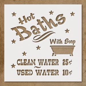 May include: A white stencil with the words "Hot Baths" and "With Soap" in a vintage font. A bathtub graphic is included. The stencil also features the text "Clean Water 25¢" and "Used Water 10¢", along with star accents.