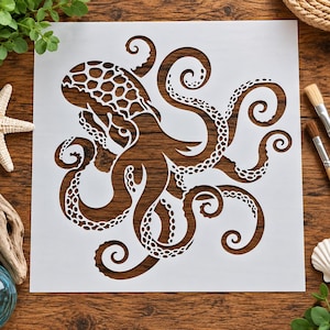May include: A square white stencil featuring a detailed laser-cut design of an octopus with a textured head pattern and eight curling tentacles. The stencil is made of a thin, flexible material and displays a clear, negative space cutout.