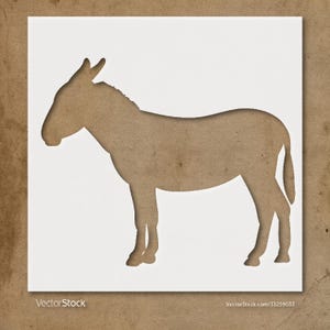 May include: A brown donkey silhouette cut out of white paper, set against a textured brown background. The donkey is in profile, with its head and tail visible. The image has a rustic, handmade feel.
