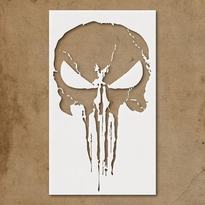 May include: A white rectangular stencil featuring a skull design with large eye sockets and dripping details. The skull is cut out, revealing a brown background. The design is reminiscent of a comic book character.