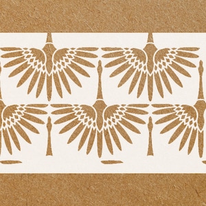 May include: A white stencil with a repeating pattern of stylized bird wings. The wings are arranged in a symmetrical pattern, with the tips of the wings pointing towards the center of the stencil.