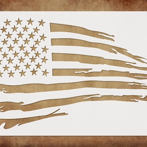 May include: A white stencil of a distressed American flag. The flag is tattered and torn, with the stars and stripes clearly visible.