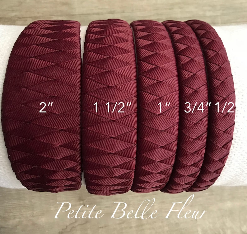 May include: A set of burgundy headbands in various widths: 2", 1 1/2", 1", 3/4", and 1/2". Each headband features a woven design. The text "Petite Belle Fleur" is displayed at the bottom.