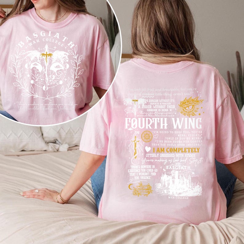 May include: Pink t-shirt with white graphic on front and back. Front graphic includes text "BASGIATH WAR COLLEGE" and a sword. Back graphic features "FOURTH WING" text and other text and illustrations.