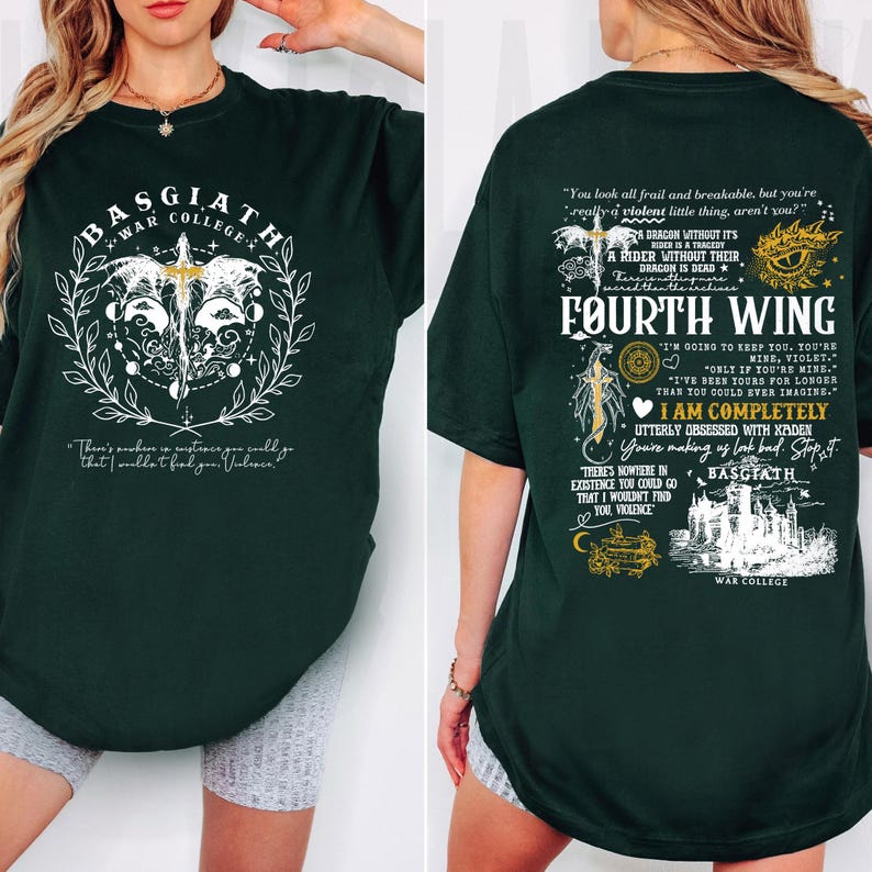 May include: Dark green t-shirt with white graphic designs and text. The front features a circular design with a sword and the words "BASGIATH WAR COLLEGE." The back displays text including "FOURTH WING" and quotes. A casual, oversized fit.