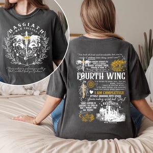 May include: Dark gray t-shirt featuring the text "BASGIATH WAR COLLEGE" and a graphic of a sword and wings. The back of the shirt has the text "FOURTH WING" and other quotes. A casual, unisex tee.