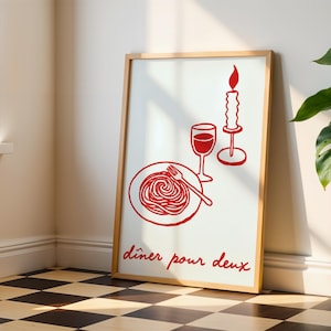Könnte beinhalten: Ein gerahmter Kunstdruck mit einer roten Strichzeichnung eines Tellers Spaghetti mit Gabel, einem Weinglas und einer brennenden Kerze. Der Text "dîner pour deux" steht in roter Schreibschrift am unteren Rand des weißen rechteckigen Drucks.