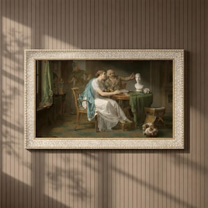 Puede incluir: Impresión enmarcada de una pintura clásica. La obra representa a una mujer sentada con un vestido blanco y un chal azul, conversando con un hombre mayor. También se ven un busto y un perro pequeño. El marco es ornamentado con un color oro claro.