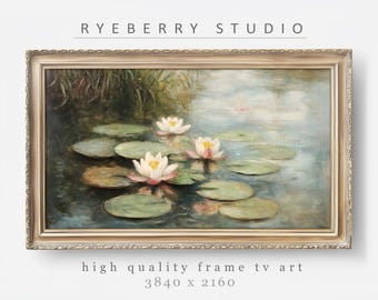 May include: A framed painting of water lilies in a pond. The painting is in a gold frame and has a light blue background. The water lilies are white with pink centers and are surrounded by green lily pads.