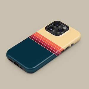 May include: A smartphone case with a retro design. The case has a navy blue lower section and a cream-coloured upper section. A series of horizontal stripes in shades of red and orange separate the two sections. The case has a glossy finish.
