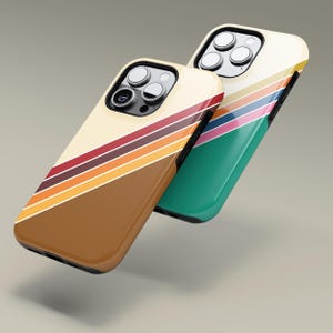 May include: Two phone cases with a retro design. One case is brown with a cream-coloured top and diagonal stripes in red, orange, and yellow. The other case is green with a cream-coloured top and diagonal stripes in pink, yellow, and blue.