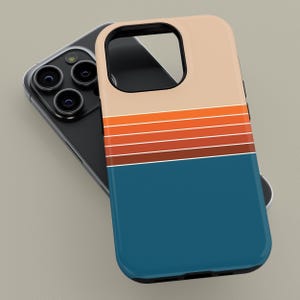 May include: A smartphone case with a retro design. The case features a colour block design with a tan top, a series of orange and brown stripes, and a blue bottom. The case is shown next to a black smartphone.