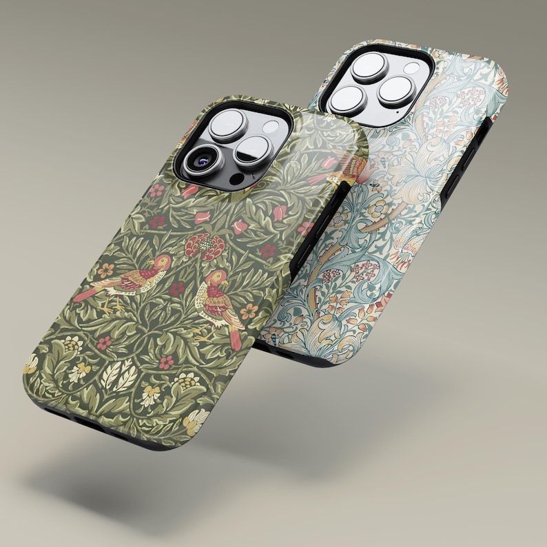 May include: Two phone cases with floral and bird patterns. One case features a green background with red and yellow birds and flowers. The other case has a blue and cream floral design. Both cases have a glossy finish and a black border.