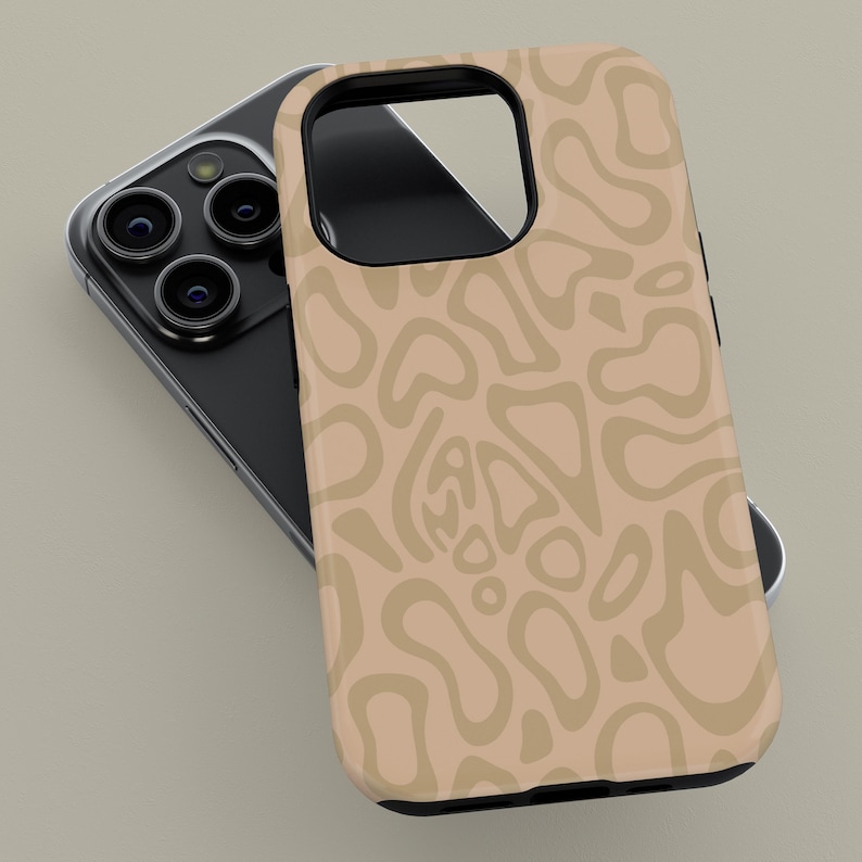 May include: A beige phone case with a repeating abstract pattern in a lighter shade of beige. The case is on top of a black smartphone with multiple camera lenses.
