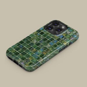 May include: A phone case for an iPhone with a green and blue mosaic pattern.
