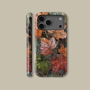 May include: A smartphone case featuring a colorful autumn leaf design. The case displays a pattern of red, orange, pink, and green leaves with dark brown outlines. The side of the case also shows the leaf pattern.
