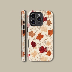 May include: A phone case with a repeating pattern of autumnal leaves in red, orange, and tan hues on a cream backdrop. The case is displayed from different angles, showcasing the design on the front and sides.
