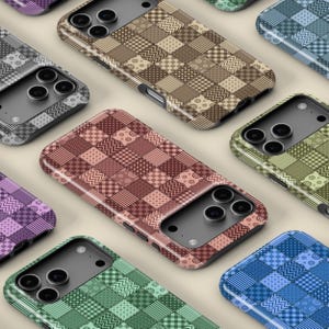 May include: A selection of phone cases with a patchwork quilt design. The cases display a variety of colours, including brown, red, green, blue, and purple. Each case has a unique pattern of squares and rectangles.